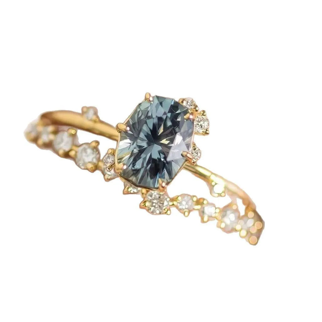 Gold electroplated women's ring with floral design and green zircon stone inlays on alloy base