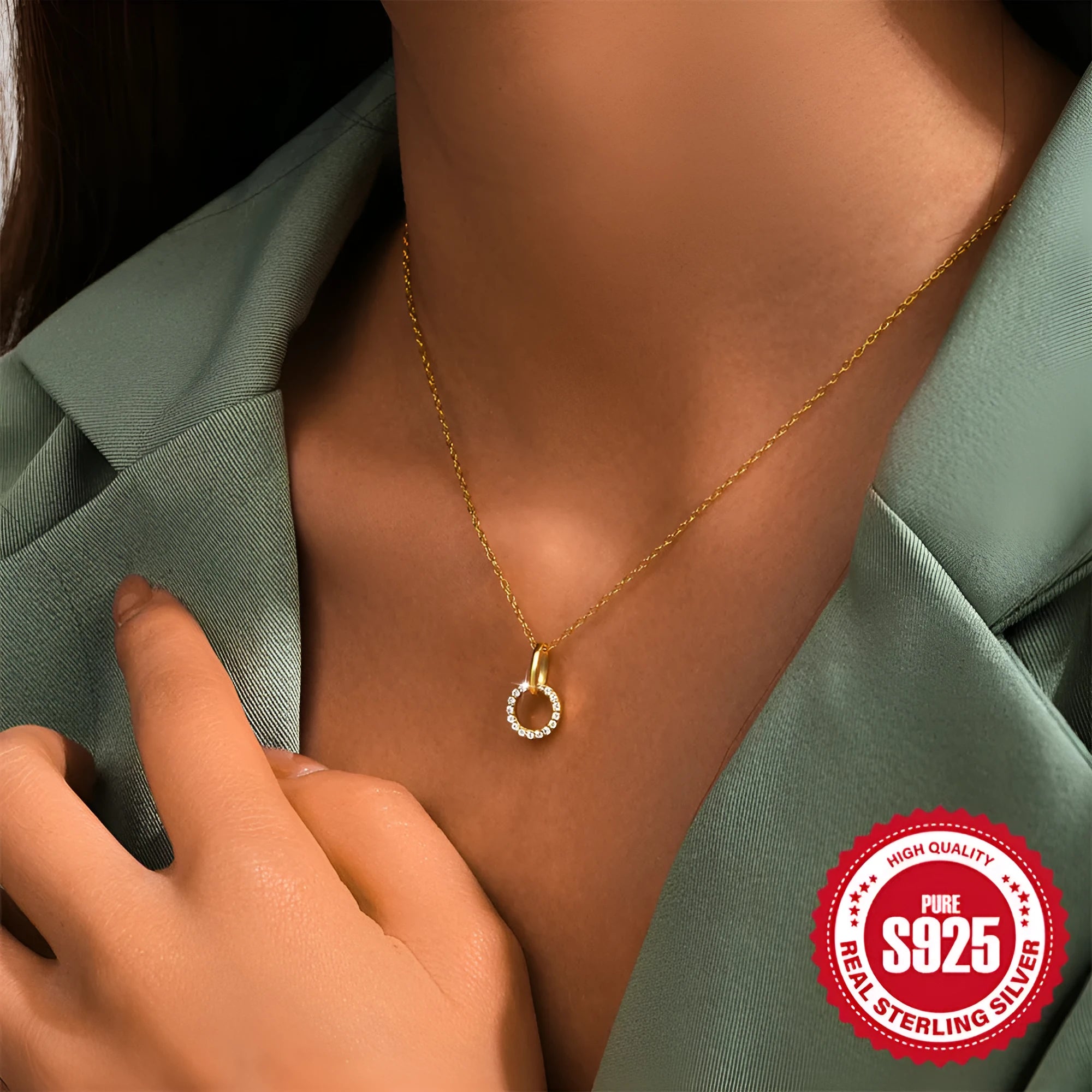 Gold-coloured sterling silver clavicle chain with interlocking geometric design and zircon stones