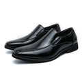 Men's black patent leather pointed toe casual shoes with a flat heel and totem design on a white background.