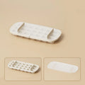 Colourful lever-action ice cube tray grid with integrated storage for its ice shovel.