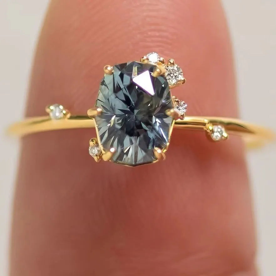 Gold electroplated women's ring with floral design and green zircon stone inlays on alloy base