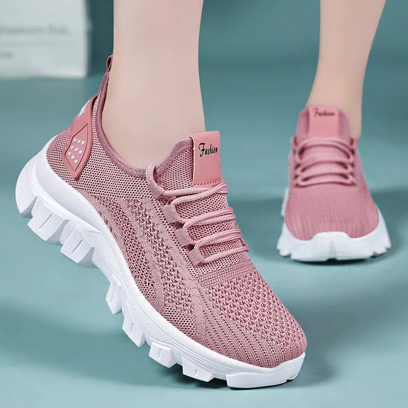 Women's white Flyknit sneaker with thick PVC sole and lace-up closure on a neutral background.