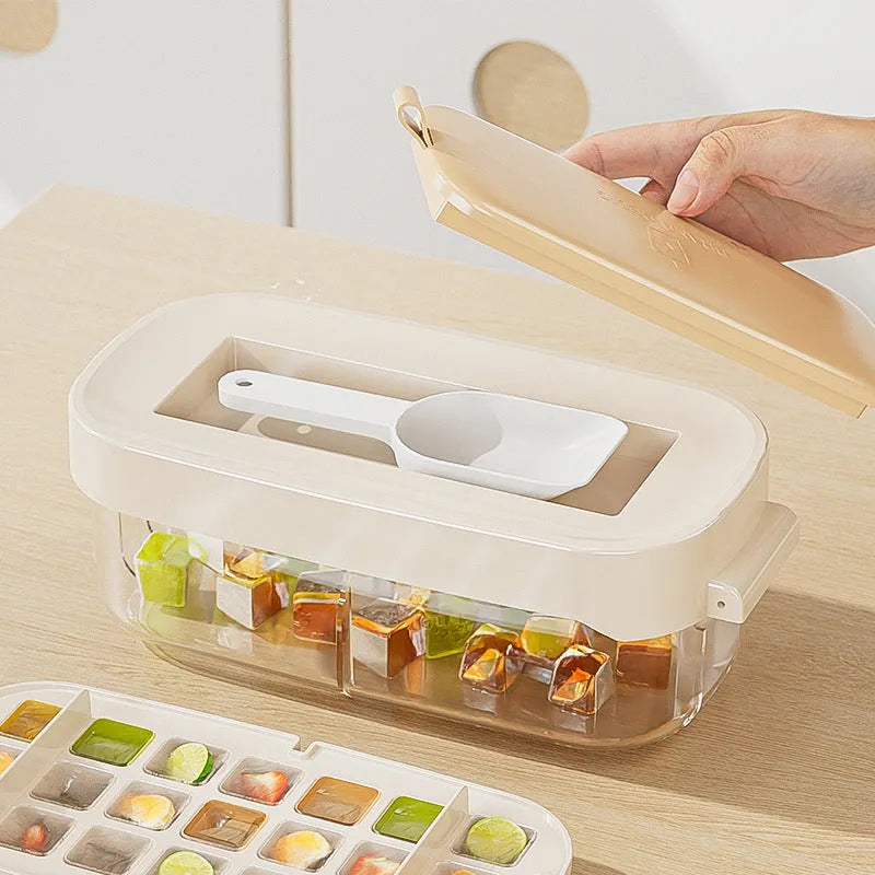 Colourful lever-action ice cube tray grid with integrated storage for its ice shovel.