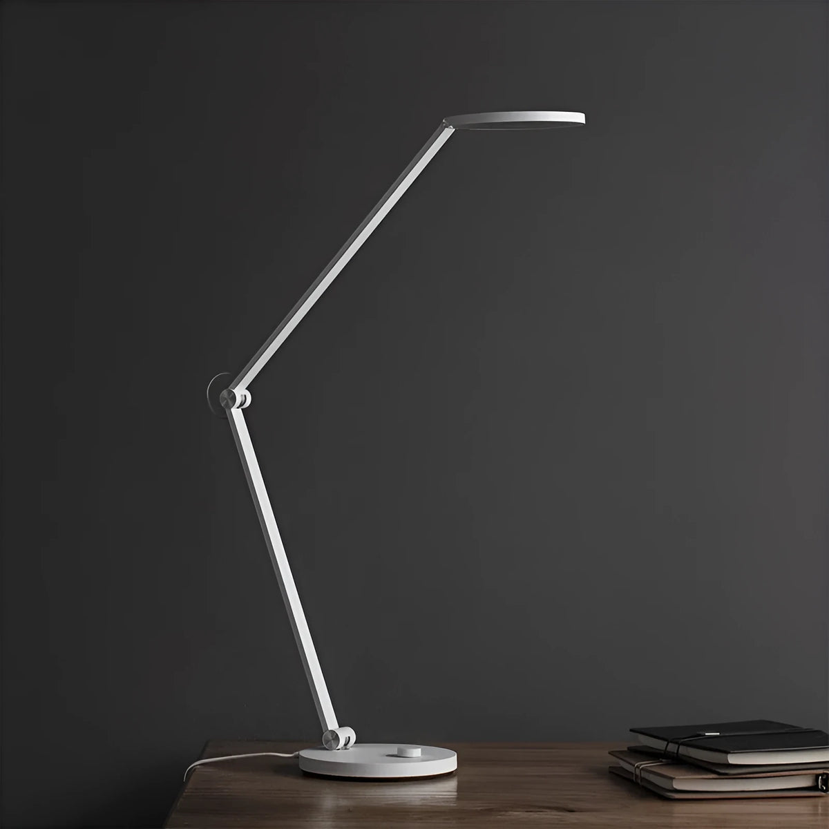 ProLED folding desk lamp with adjustable colour temperature and smart connectivity on a wooden desk.