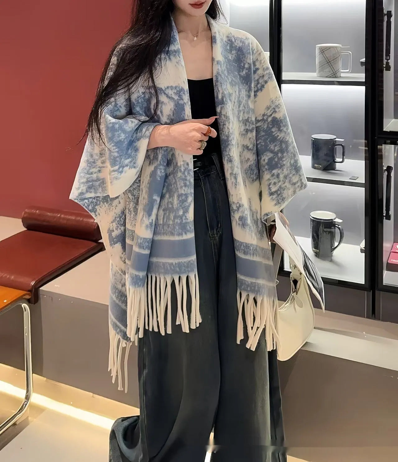 Women's personalised tassel scarf cape in polyester fabric showing decorative detailing