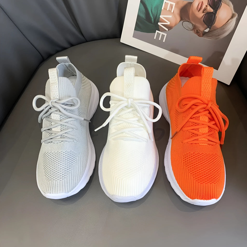 Women's low-top mesh running shoe in creamy white with a round toe and flat rubber sole.