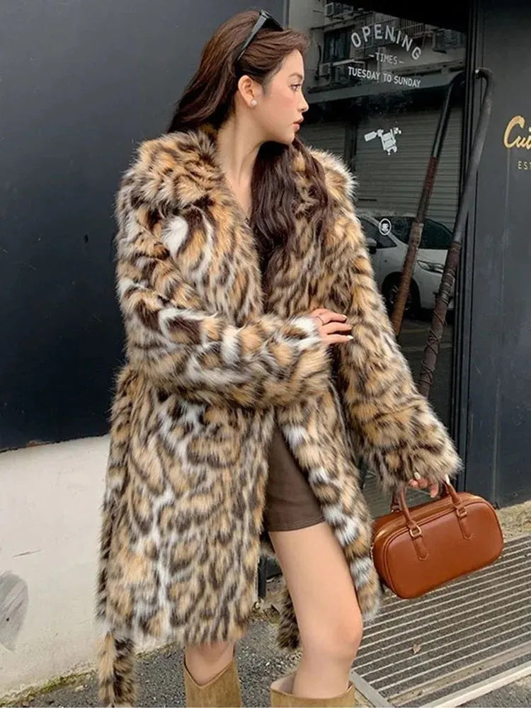 A street-fashion faux fur coat with a fox print pattern and a fur collar, shown in a long style.