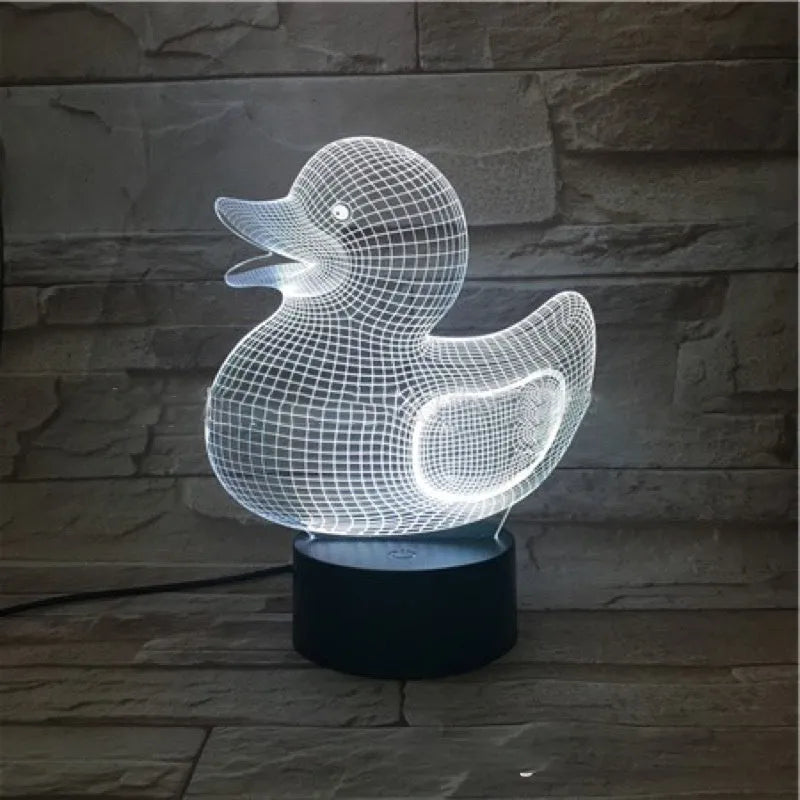 Little yellow duck 3D night light with remote control on a bedside table, showing colour change