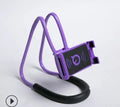 Universal 360-degree rotating phone holder in multiple colours on a table, holding a smartphone.