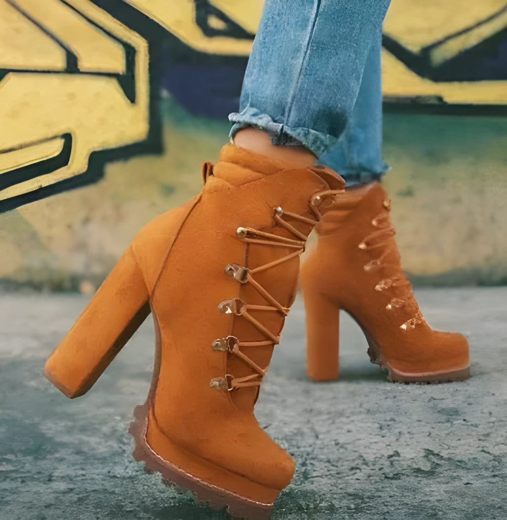 Women's suede ankle boots with thick heels, buckle straps, and rivet details in four colour options