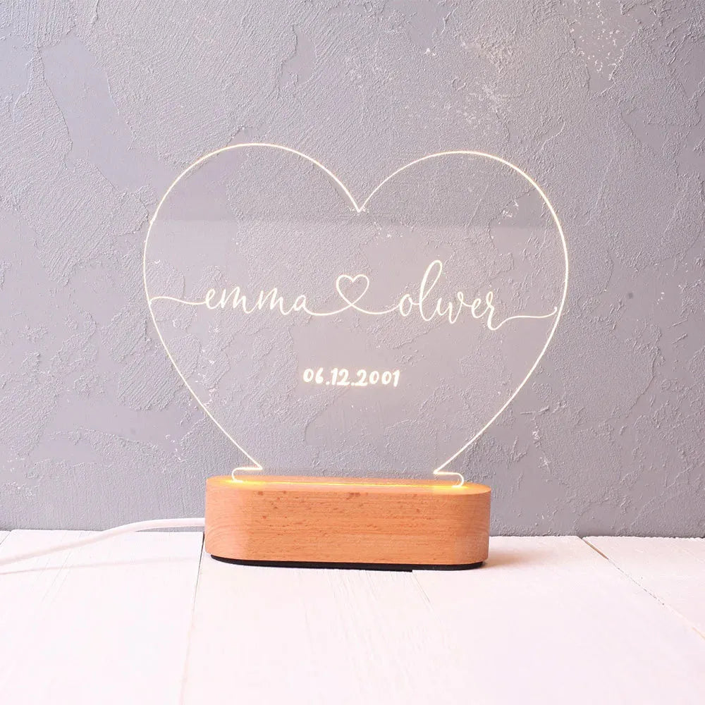 Custom couple names and date engraved on a transparent acrylic LED night light.
