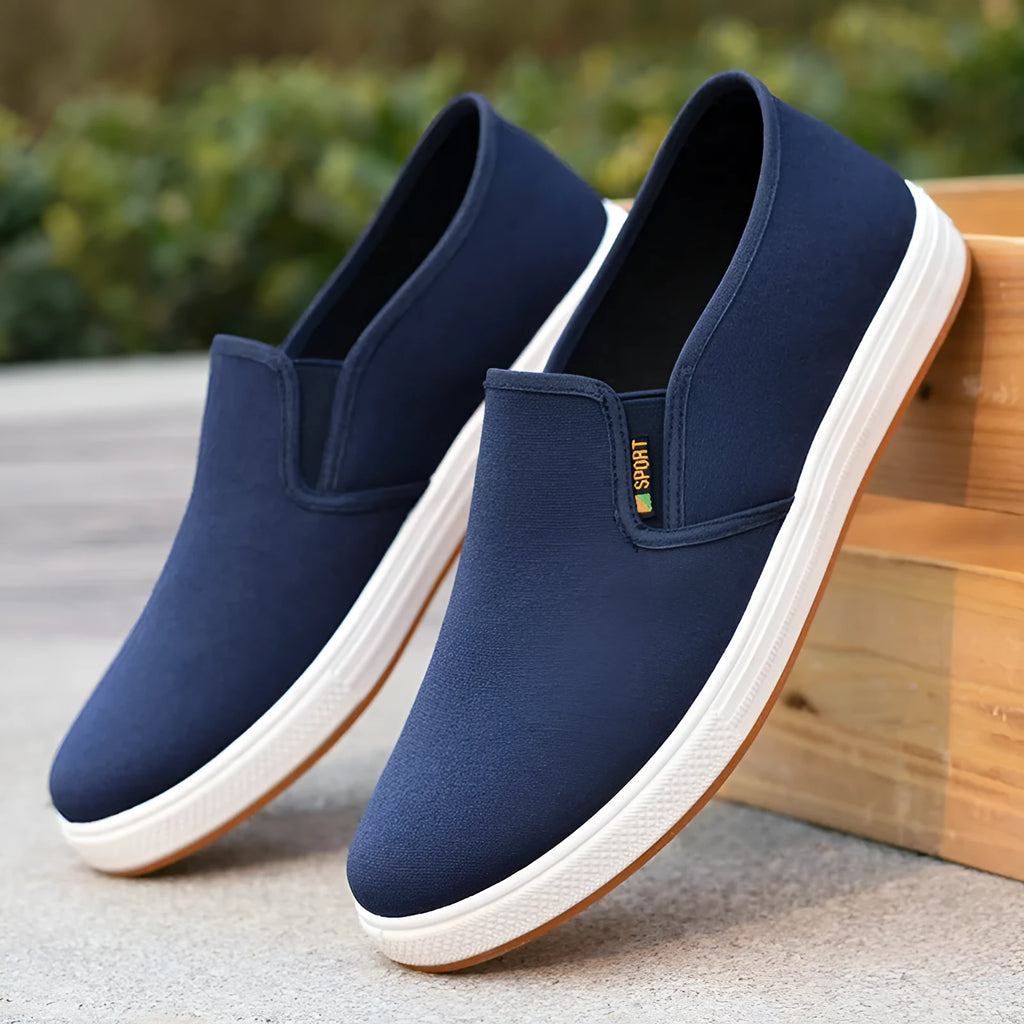 Men's low-top canvas slip-on shoes in blue colour showing round toe and shallow mouth design