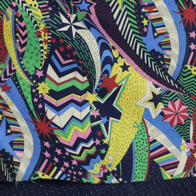 Blue cotton fabric with digital print of plants and flowers, showing 145cm width.