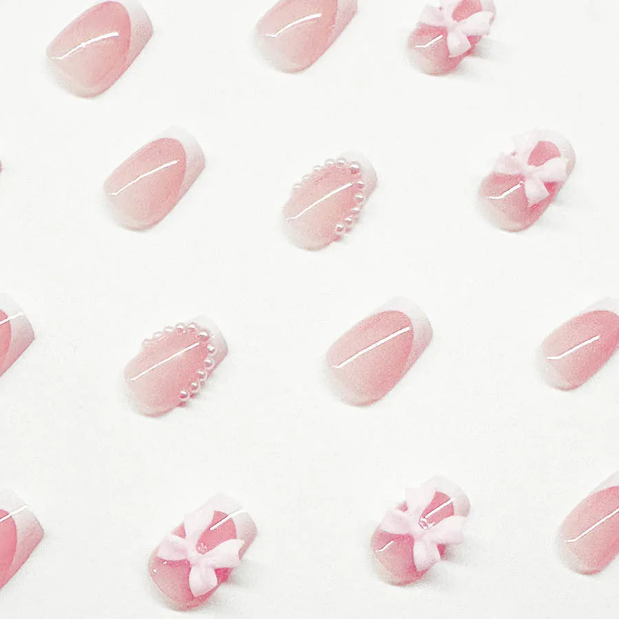 Short white square false nails with bow French manicure design and tulip patterns