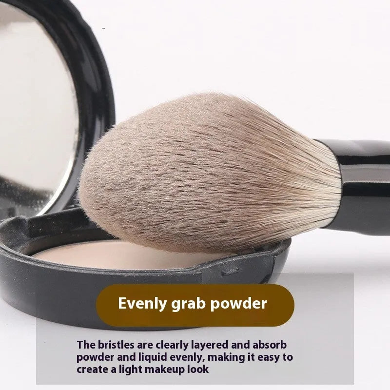 12 makeup brushes with wooden handles stored in a black PU roll, showing the powder foundation brush.