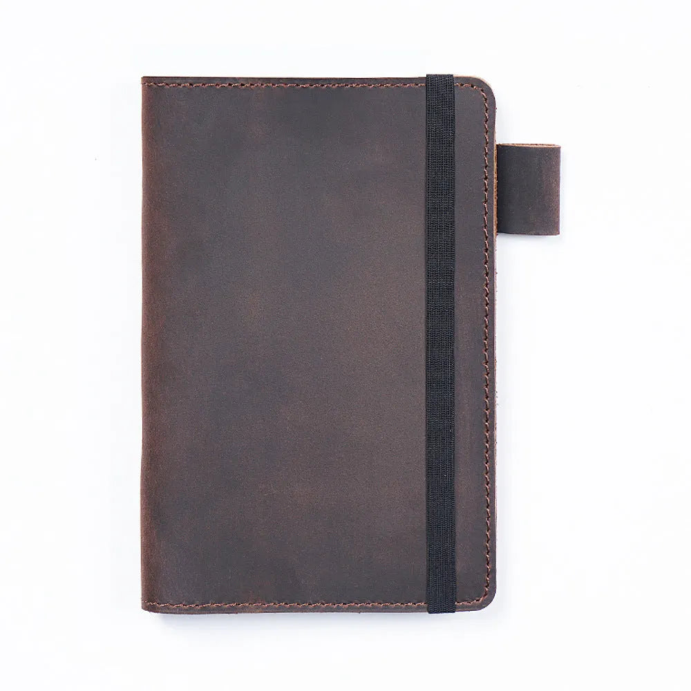Handmade old-fashioned kraft notebook with cowhide cover, open to show wood-free paper pages.