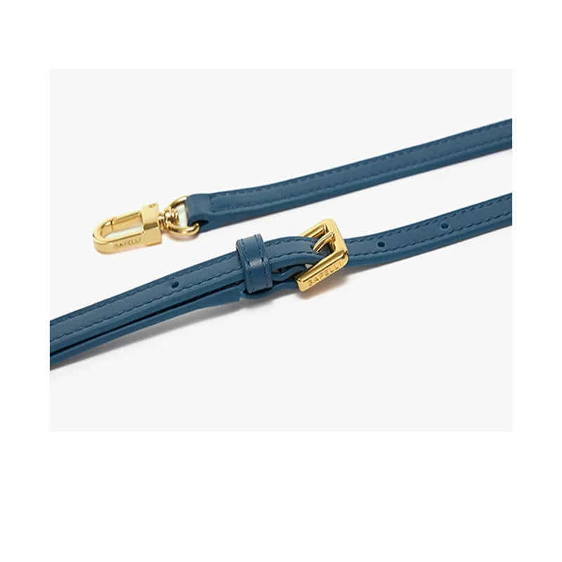 A wing-shaped women's leather tote bag with a buckle latch, shown in blue with a cross-body strap.