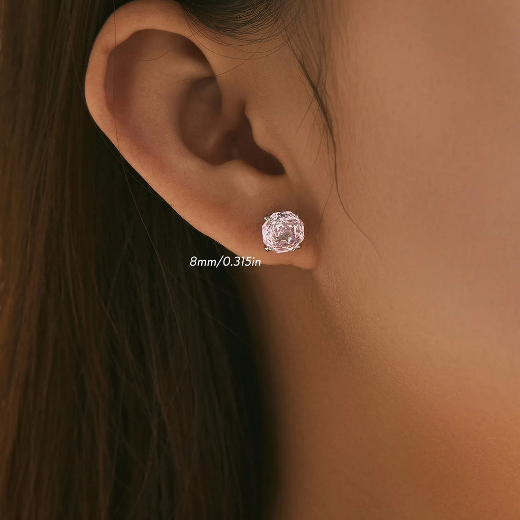 Close-up of a pair of pink rose-shaped stud earrings made of S925 sterling silver, shown front and back.