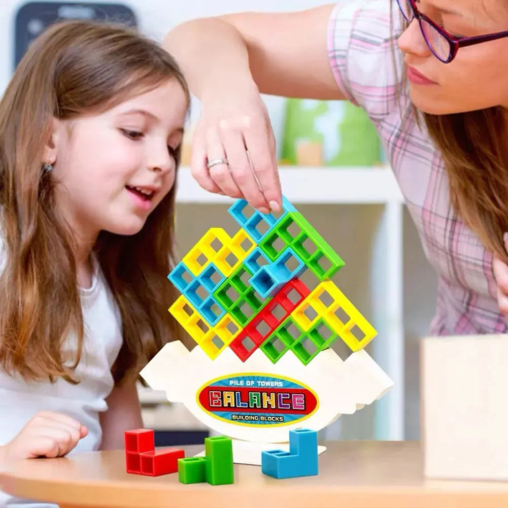 Plastic balance stacking board game with 16 coloured blocks, chassis, and base on a table