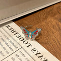 Copper butterfly women's ring with drip oil finish in an open-loop design.