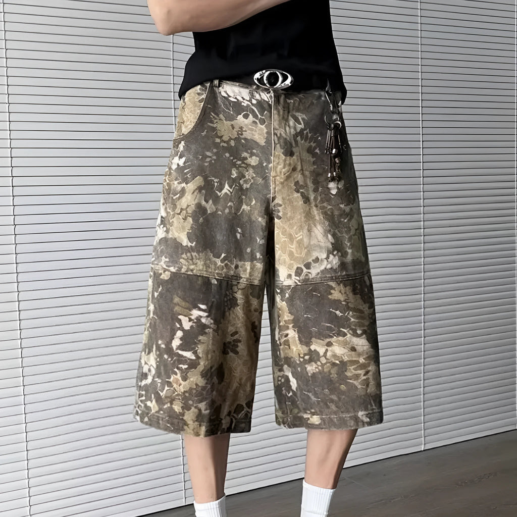 Women's yellow snake pattern camouflage print cropped denim jeans laid flat.