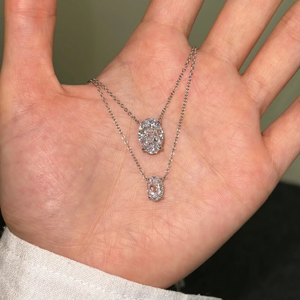 Sterling silver necklace with a geometric oval ice flower pendant in gold or platinum finish.