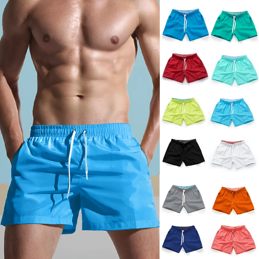 Men's plus size polyester surf shorts on a beach, showing straight leg fit in black and emerald green colours.