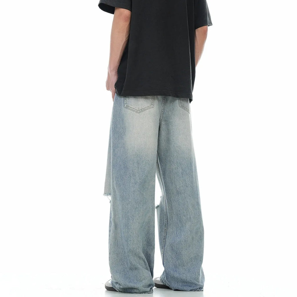 Blue men's straight-leg ripped jeans on a plain background showing cotton blend fabric and zipper fly.