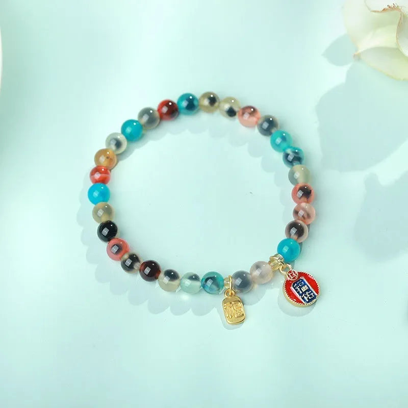 Women's agate snake bracelet with copper coin detailing and coloured glaze accents in geometric design