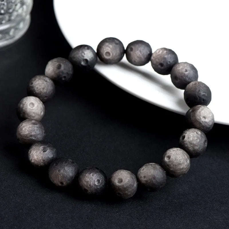 Natural obsidian crater ball bracelet with grinding finish in silver or golden meteorite colours with various bead sizes