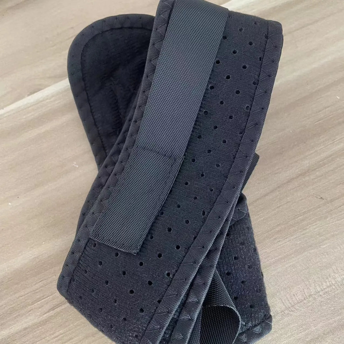 Babaka adjustable nylon posture correction band worn for upper back support.