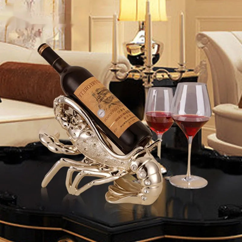Lobster wine rack ornament in rose gold or silver metallic finish holding bottle
