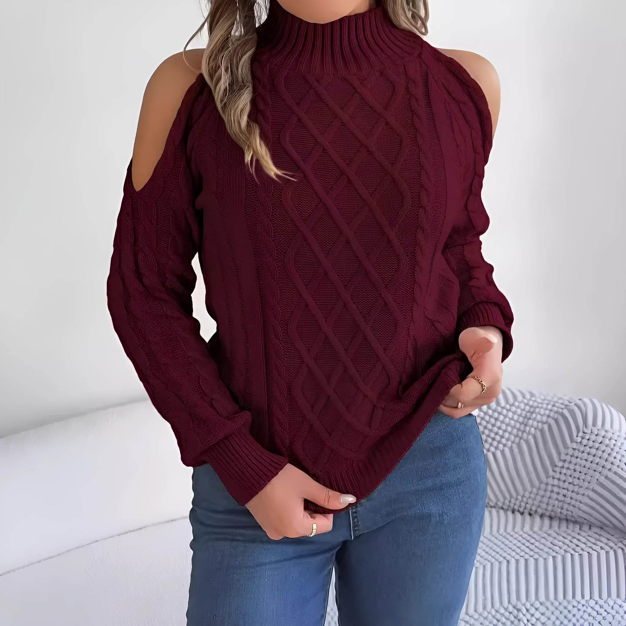 A woman's strapless, twisted-knit sweater with long lantern sleeves and a half-high collar.