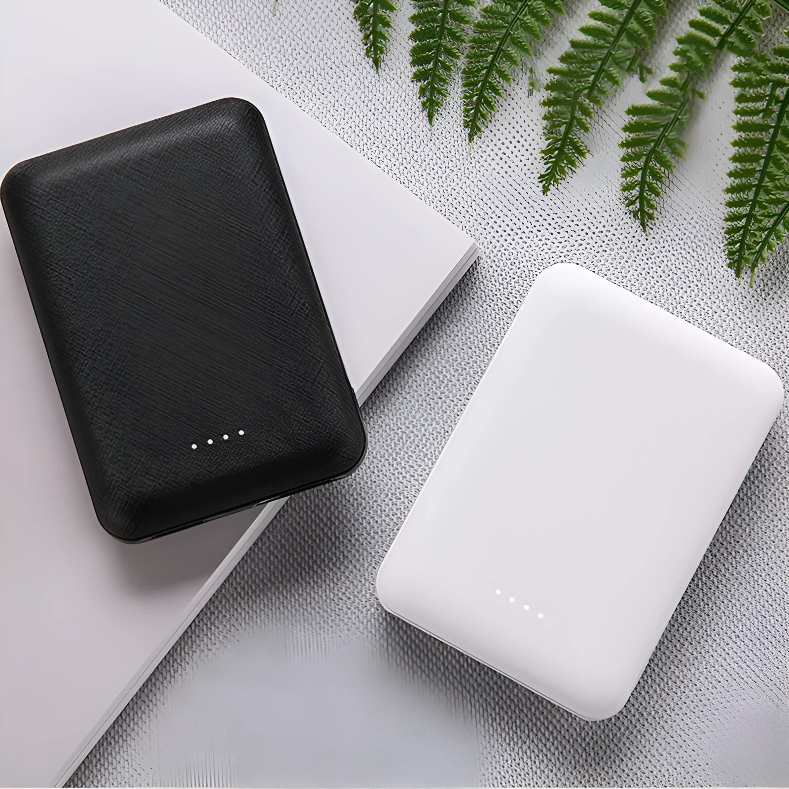 Black and white ultra-thin power bank showing 90x63x22mm dimensions with multiple USB charging ports