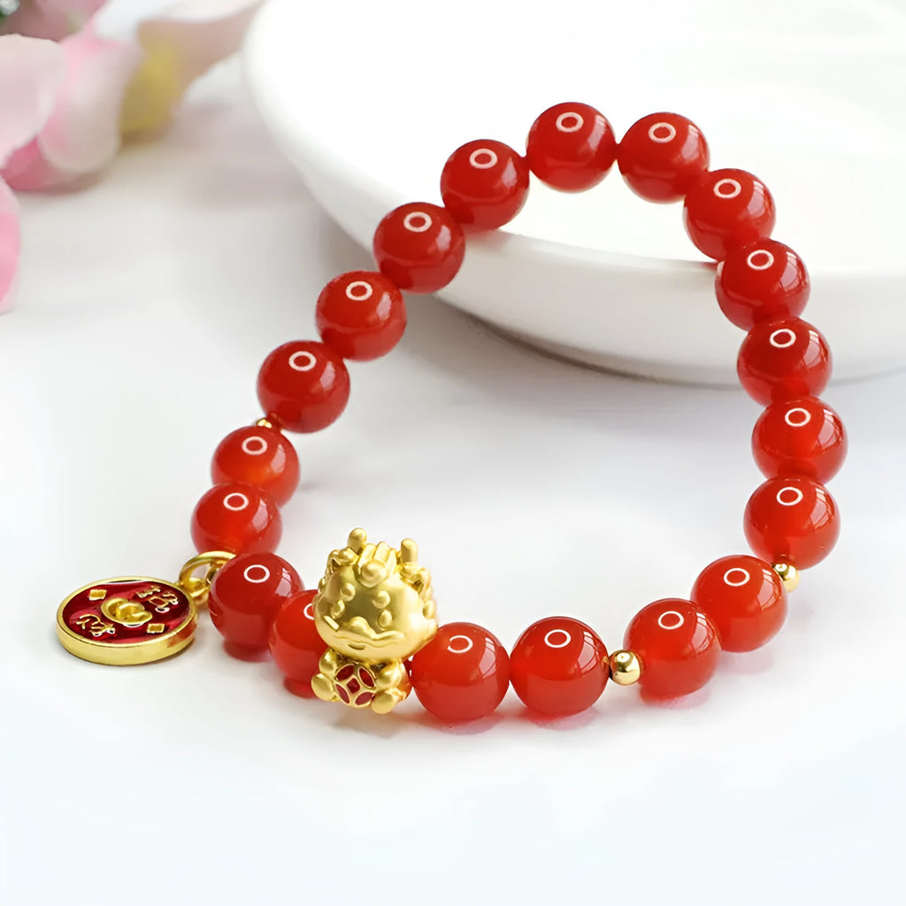 Red agate Chinese zodiac dragon bracelet with 8mm round beads on an adjustable cord.