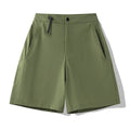 Man wearing khaki quick-drying sports shorts with an elastic waistband for running or climbing.