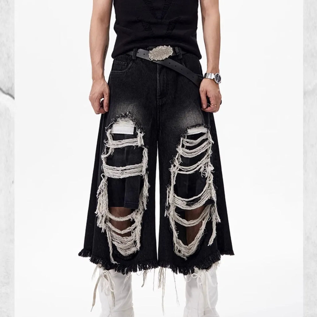 Women's black cropped wide leg jeans with mid-high waist and ripped patch detailing