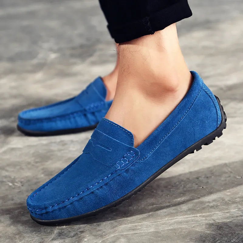 Men's brown suede Gommino casual shoes with round toe and flat rubber sole on a white background
