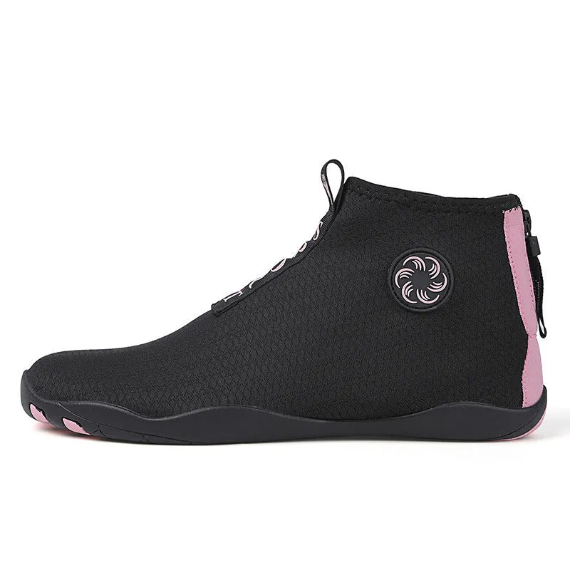 Men's black and fluorescent green quick-dry mesh beach shoes with a non-slip rubber sole on a rocky surface.