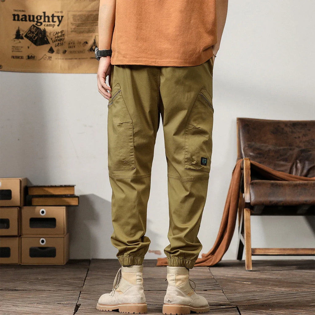 Men's tapered harem pants in cotton fabric showing ankle banded design and small leg opening