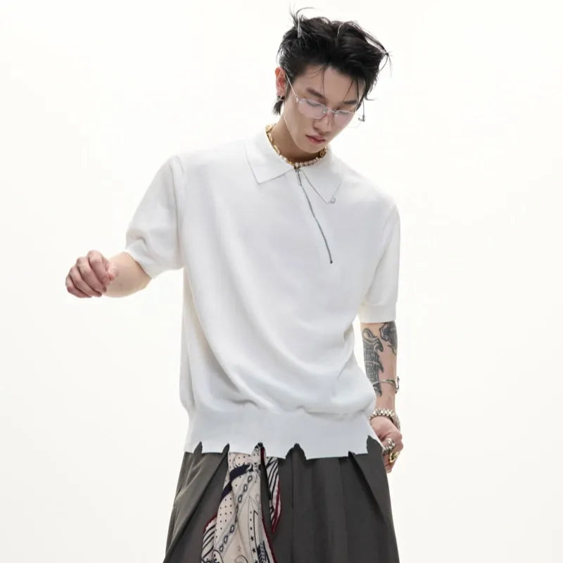 Man modelling a slim-fit black knitted polo shirt with a diagonal oblique zip and lapel collar.