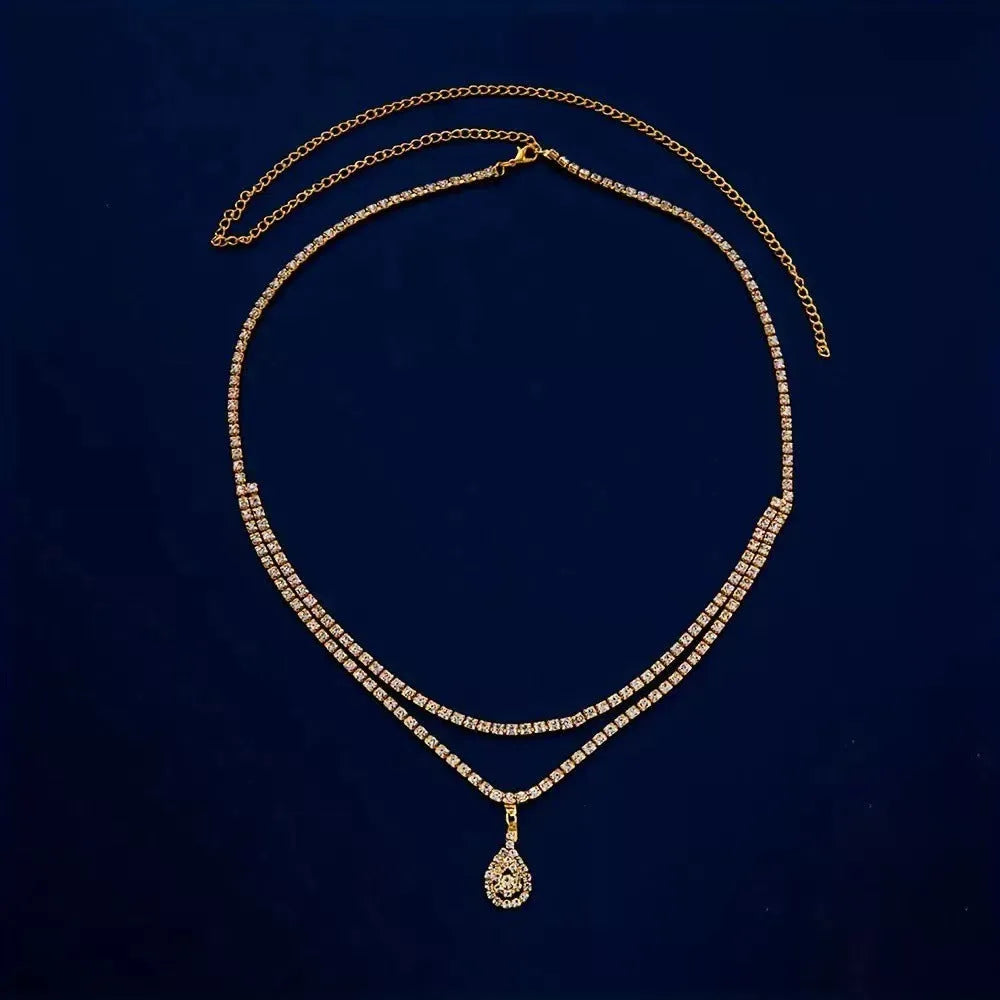 Gold or silver rhinestone waist chain with water drop pendant and tassel elements, showing lobster clasp closure