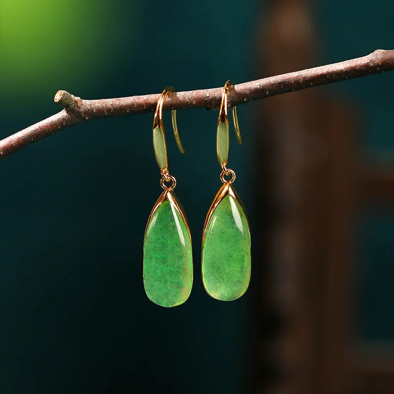 A pair of jade-coloured geometric copper earrings with a water drop element in a Chinese style.