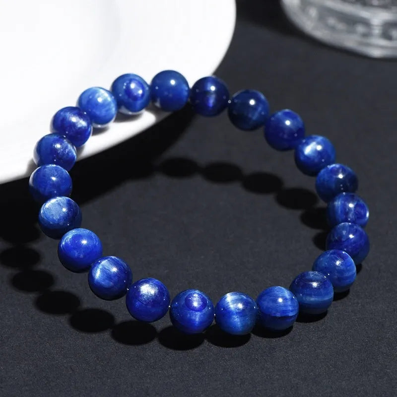 Natural blue crystal geometry ball bracelet with Ruyi charm on a white background.