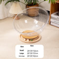 Transparent acrylic cat space capsule bed on a wooden base, showing its bathtub-style design.