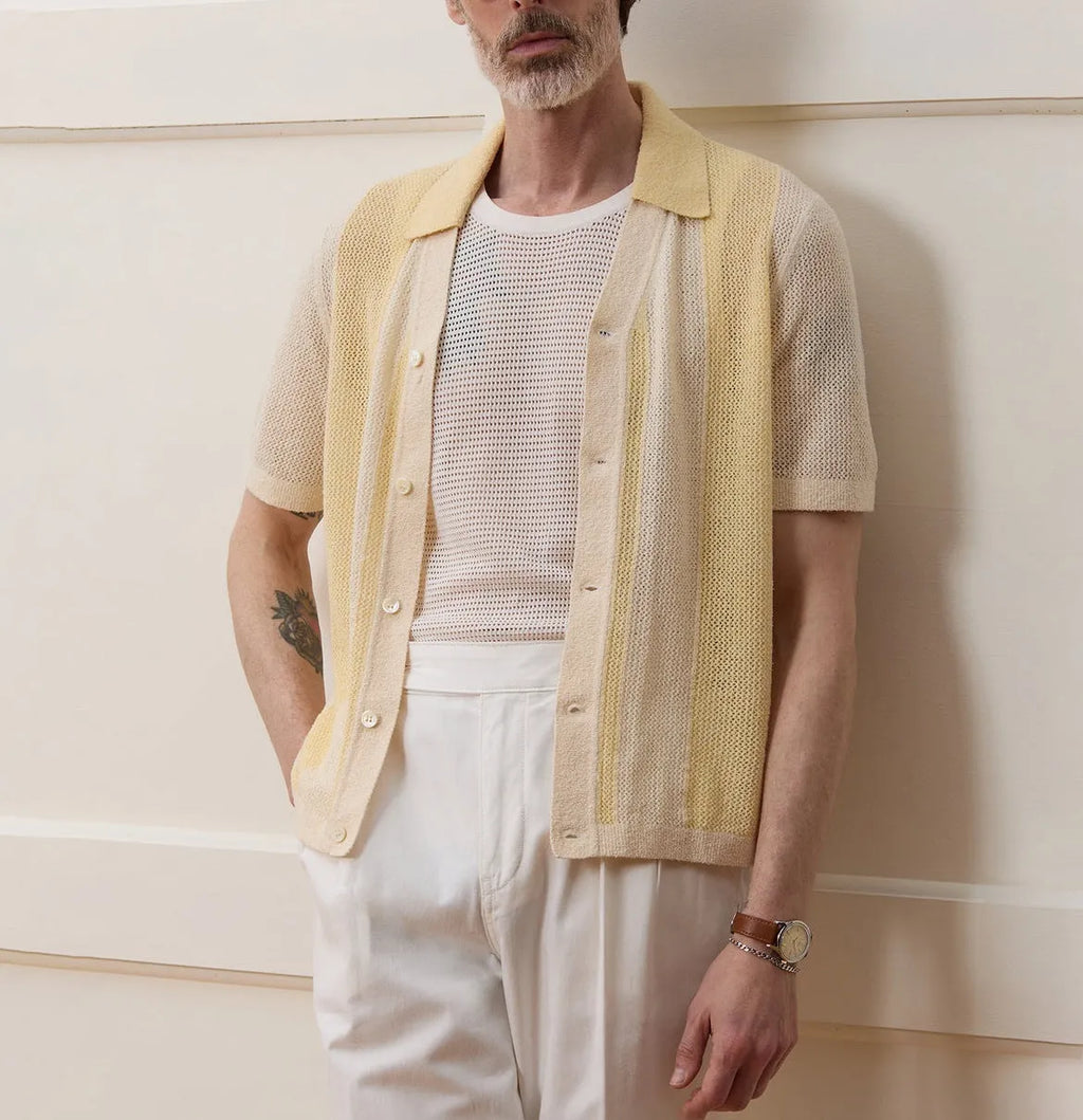 Yellow asymmetric hollow-out short-sleeved polo shirt on a hanger