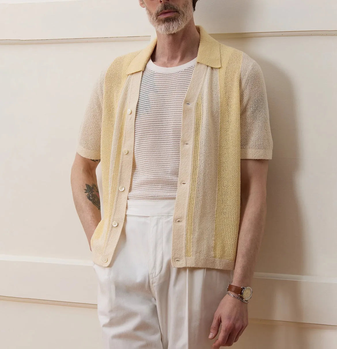 Yellow asymmetric hollow-out short-sleeved polo shirt on a hanger