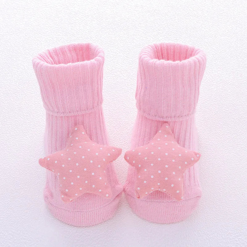 Cotton baby floor socks in a selection of colours and patterns like panda, lion, and bows, shown in sizes for infants.