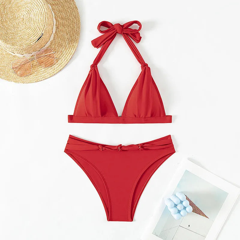 Red women's lace-up halterneck bikini set with split-bottom shorts on mannequin