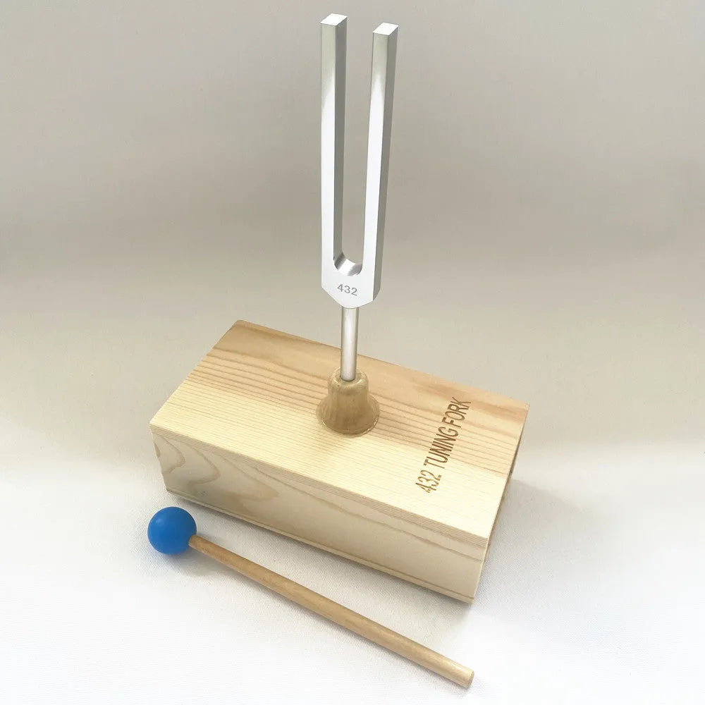 Aluminium alloy 432 Hz tuning fork with built-in speaker on kraft paper box.